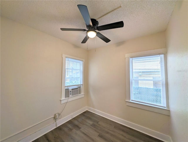 spare room with ceiling fan, dark hardwood / wood-style flooring, a healthy amount of sunlight, and a textured ceiling