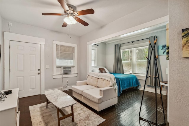 bedroom featuring dark hardwood / wood-style floors, cooling unit, and ceiling fan