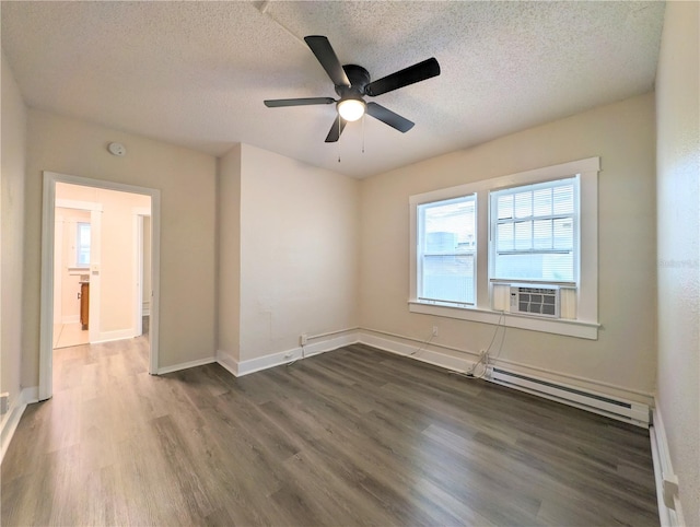 spare room with ceiling fan, cooling unit, a baseboard heating unit, a textured ceiling, and dark hardwood / wood-style flooring