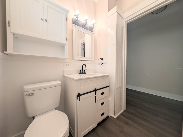 bathroom featuring vanity, hardwood / wood-style floors, and toilet