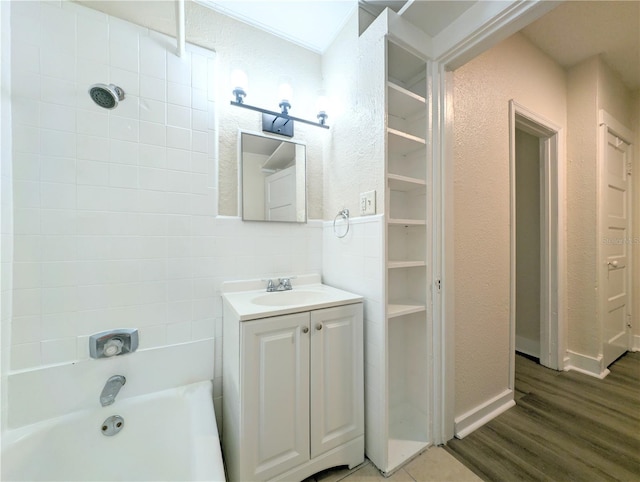 bathroom with vanity, wood-type flooring, bathing tub / shower combination, and tasteful backsplash