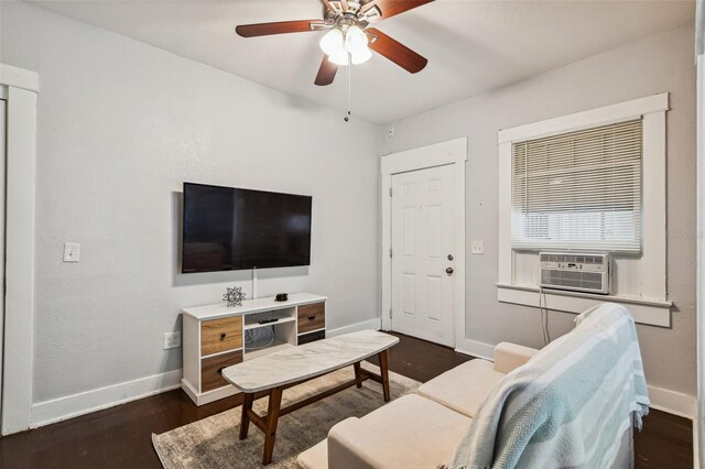 living room featuring ceiling fan, cooling unit, baseboards, and dark wood finished floors