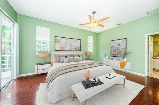 bedroom featuring baseboards, visible vents, and wood finished floors