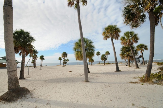 view of community with volleyball court and a water view