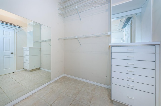 spacious closet with light tile patterned floors