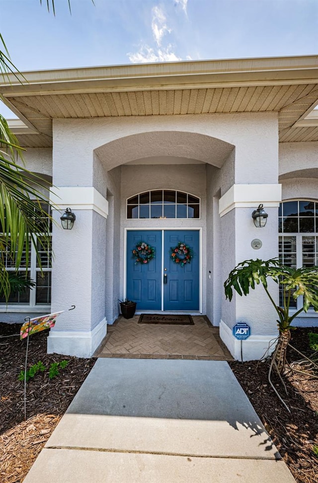 doorway to property with stucco siding