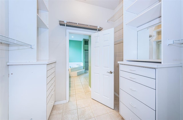 spacious closet with light tile patterned floors