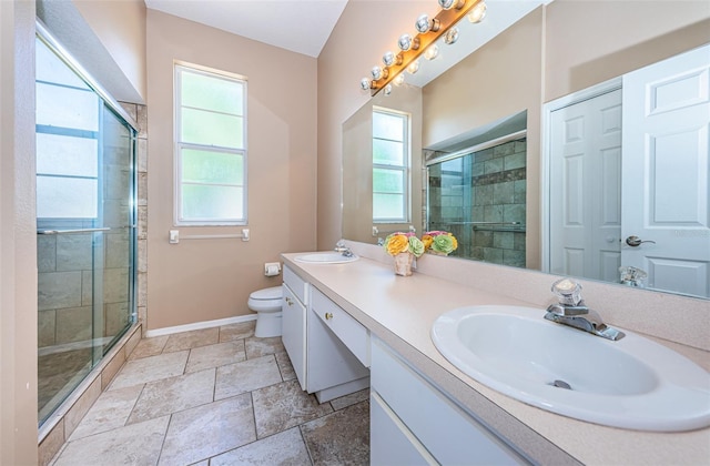 full bathroom with toilet, a sink, a shower stall, and baseboards