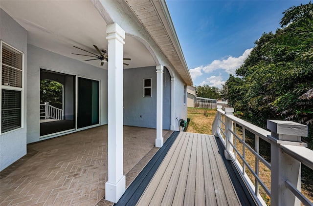 wooden deck featuring ceiling fan