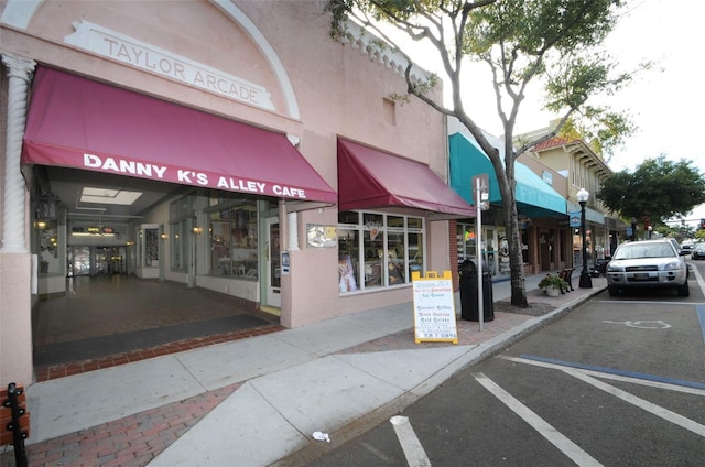 view of building exterior featuring uncovered parking