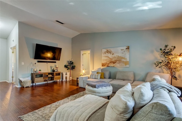 living room featuring hardwood / wood-style flooring and vaulted ceiling