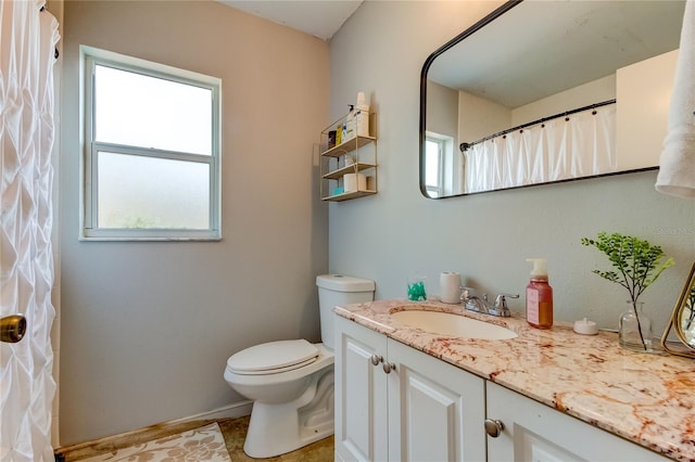 bathroom featuring tile patterned floors, vanity, and toilet