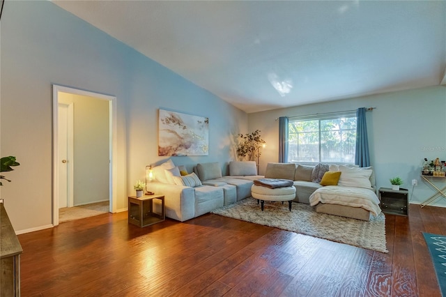 living room featuring dark hardwood / wood-style flooring and vaulted ceiling