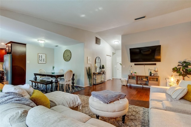 living room featuring dark hardwood / wood-style floors and lofted ceiling