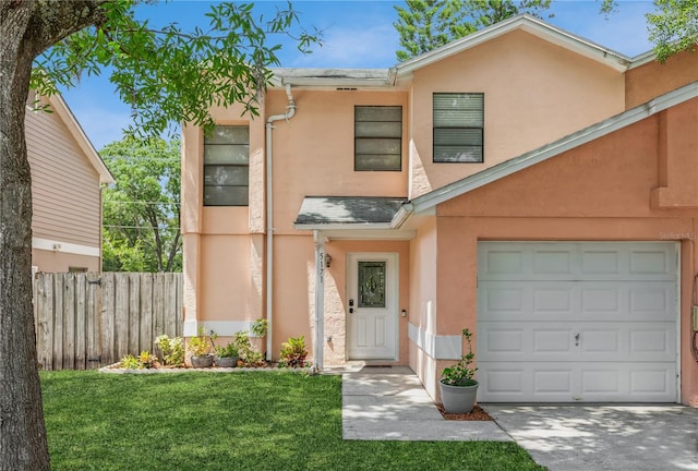 view of front of house featuring a front lawn and a garage