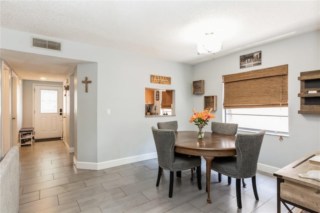 dining area featuring a textured ceiling