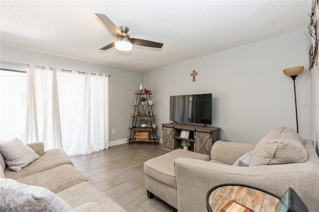 living room featuring a textured ceiling and ceiling fan