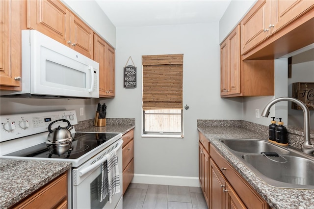 kitchen featuring sink and white appliances