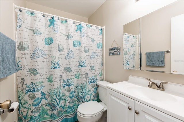 bathroom featuring a shower with curtain, vanity, and toilet