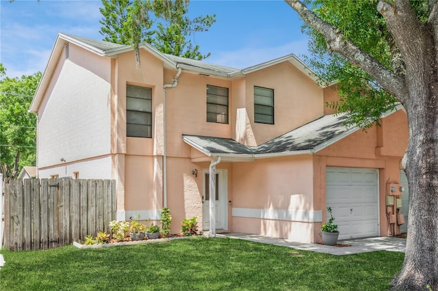 view of front of house with a garage and a front lawn