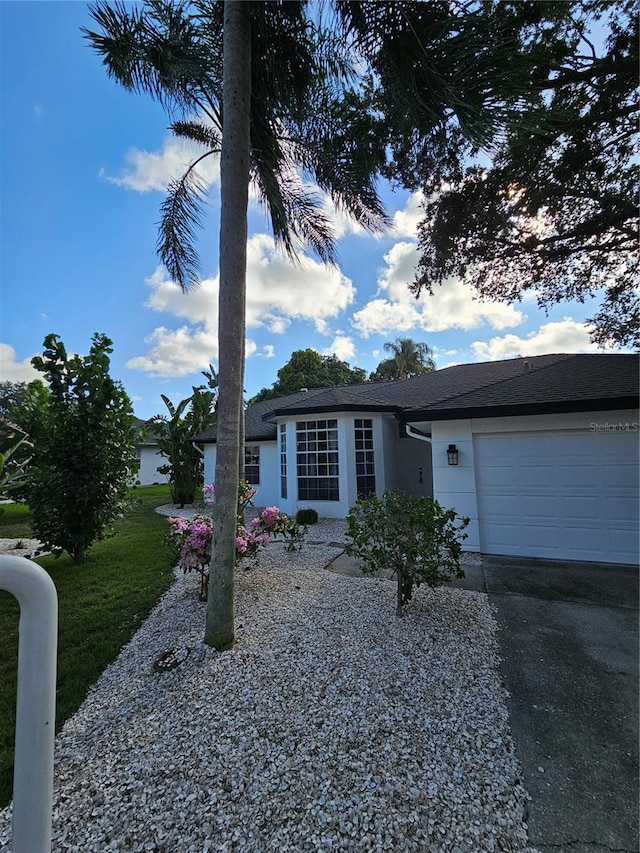 single story home with a front lawn and a garage