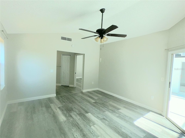 unfurnished room with a wealth of natural light, ceiling fan, light hardwood / wood-style flooring, and lofted ceiling