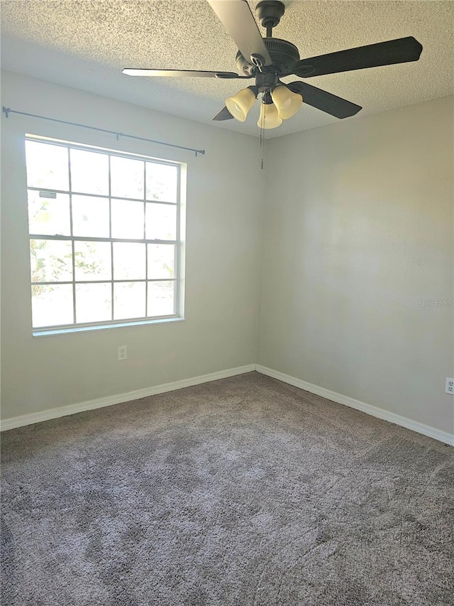 spare room featuring carpet flooring, a textured ceiling, plenty of natural light, and ceiling fan