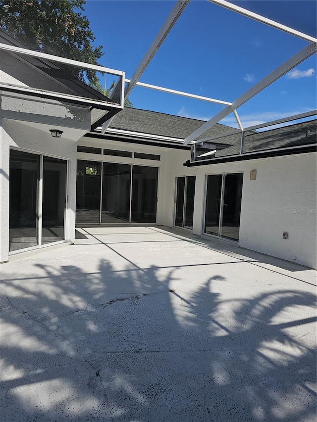 view of patio / terrace featuring glass enclosure