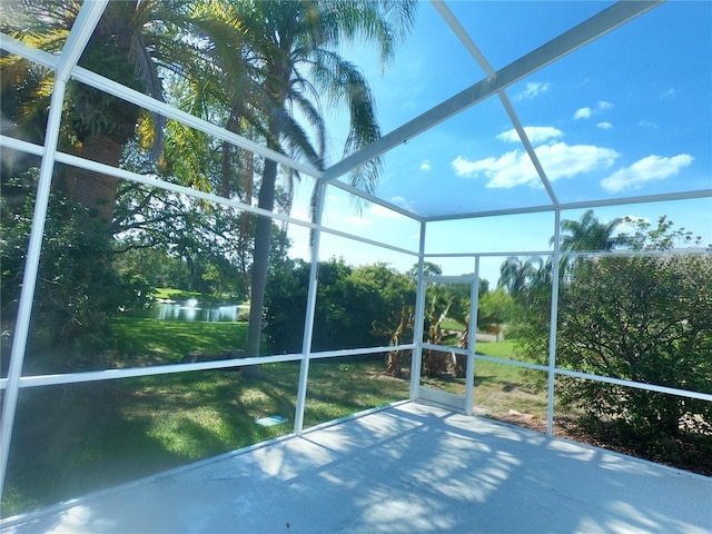 unfurnished sunroom with a water view