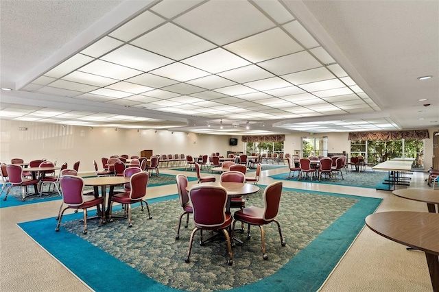 dining room featuring a paneled ceiling and carpet floors