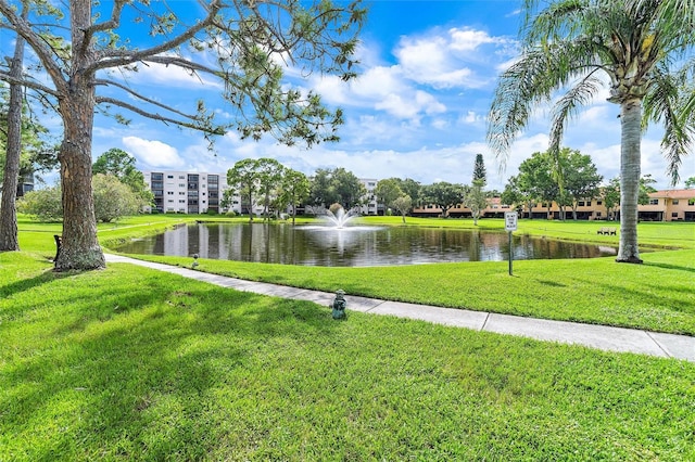 view of community featuring a water view and a lawn