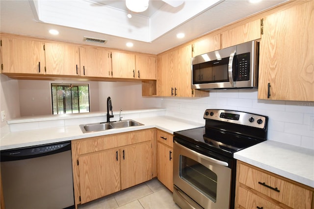 kitchen featuring sink, light brown cabinets, and stainless steel appliances