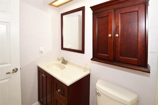 bathroom featuring toilet and vanity