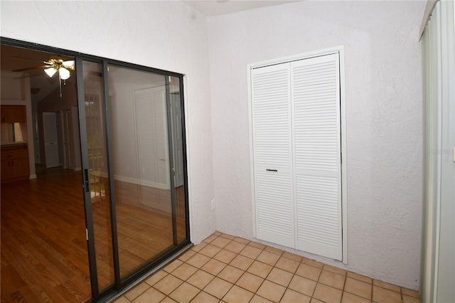 unfurnished bedroom featuring ceiling fan and light tile patterned flooring