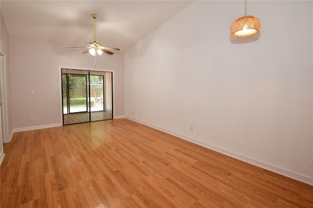 spare room featuring vaulted ceiling, ceiling fan, and light hardwood / wood-style floors