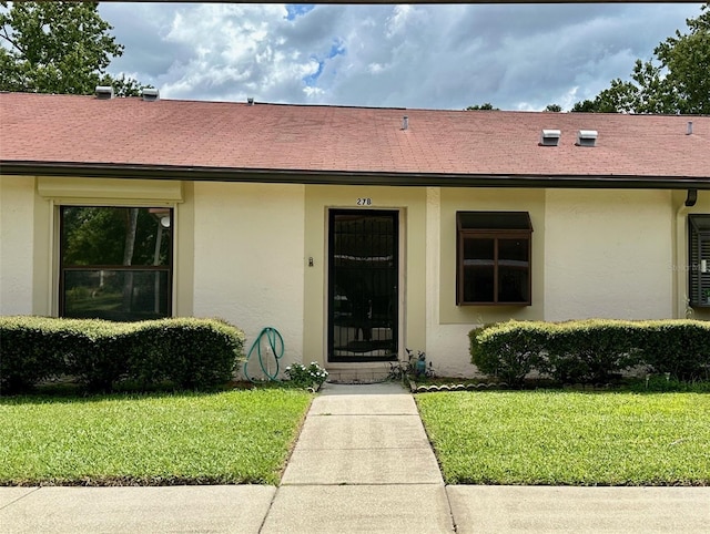 property entrance with a yard