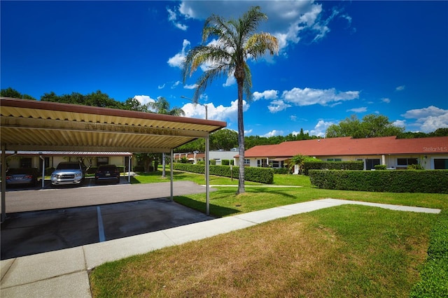 view of car parking featuring a carport and a yard