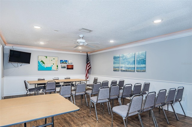 cinema with a textured ceiling, ceiling fan, crown molding, and dark wood-type flooring