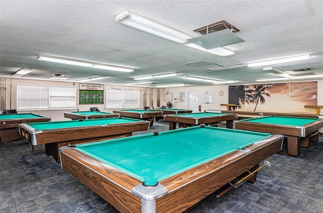 recreation room with a textured ceiling and billiards