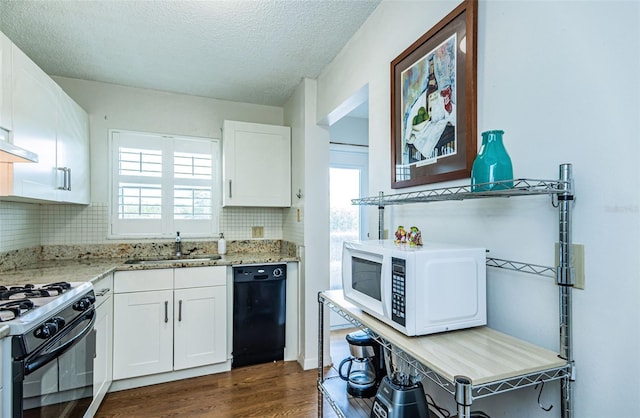 kitchen with white cabinets, sink, plenty of natural light, and black appliances