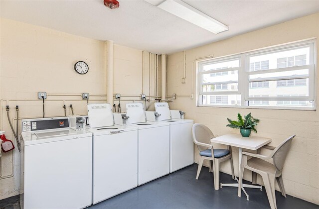 clothes washing area with washing machine and dryer