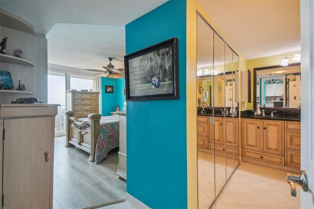 hall with a sink and a textured ceiling