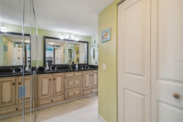 bathroom with vanity, a textured ceiling, and an inviting chandelier