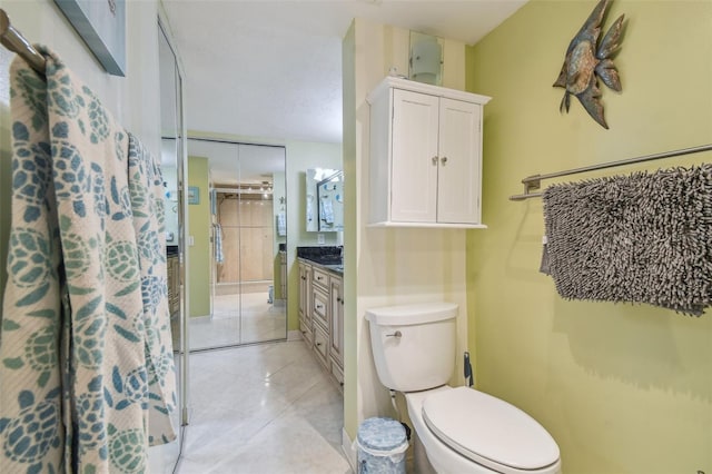 full bathroom featuring tile patterned flooring, vanity, and toilet