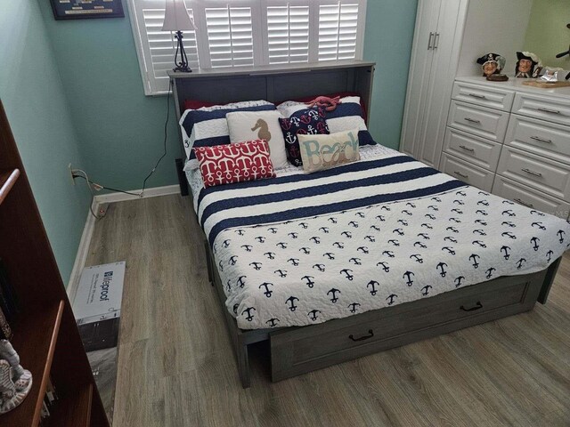 bedroom with dark wood-type flooring