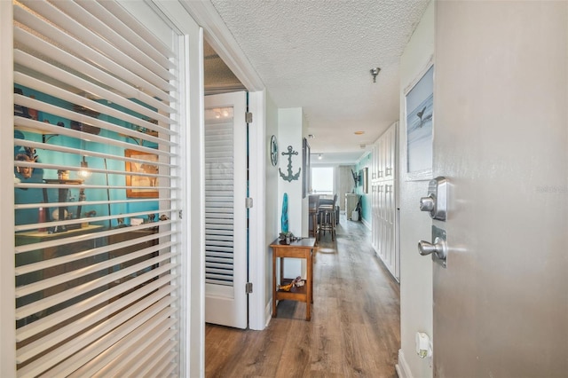 6035 Sea Ranch Dr Unit 505, Hudson, FL 34667 - hallway featuring wood finished floors and a textured ceiling