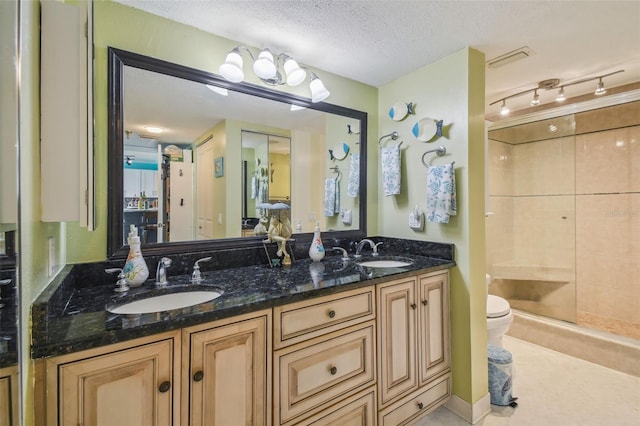 6035 Sea Ranch Dr Unit 505, Hudson, FL 34667 - bathroom with a stall shower, toilet, double vanity, a textured ceiling, and tile patterned floors
