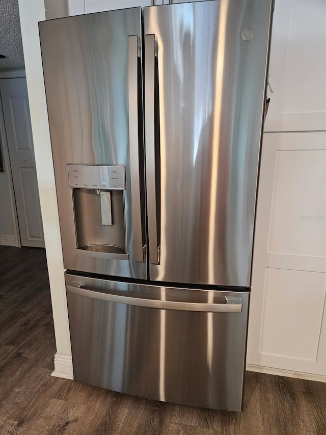 6035 Sea Ranch Dr Unit 505, Hudson, FL 34667 - detailed view of stainless steel fridge, dark wood-style floors, and white cabinetry