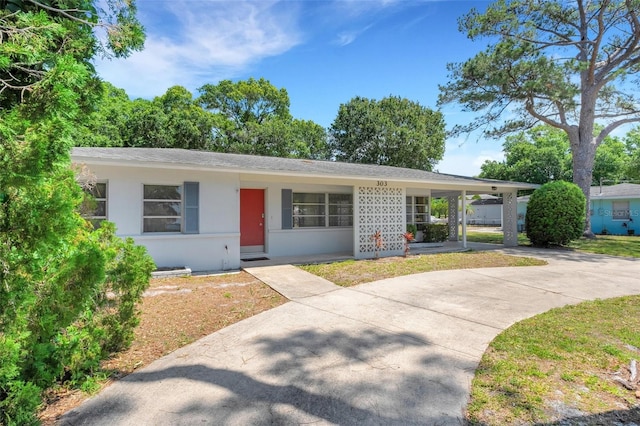 ranch-style home featuring a carport