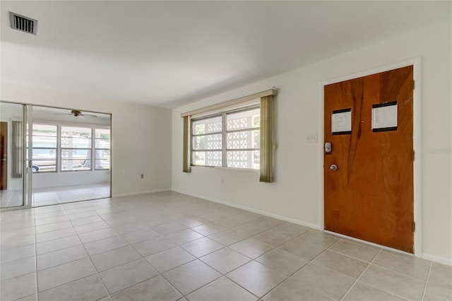 foyer entrance with light tile patterned floors and ceiling fan